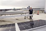 Ban Ki-moon on the roof of UN City, which has been outfitted with wind turbines and solar panels. Ban Ki-moon on the roof of UN City, which has been outfitted with wind turbines and solar panels.