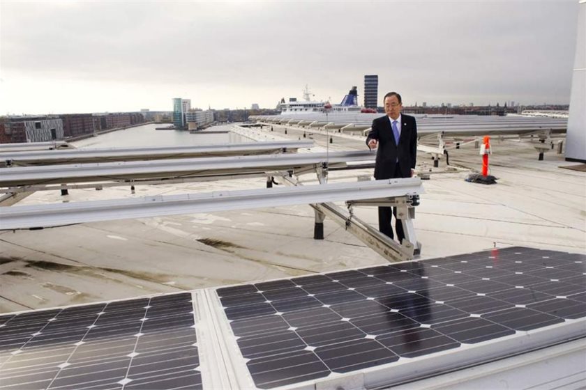 Ban Ki-moon on the roof of UN City, which has been outfitted with wind turbines and solar panels.