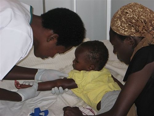 A child is treated for maleria .. 150,000 climate-change deaths already each year