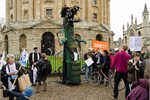 A fossil fuel 'dinosaur' at a divestment campaign protest in Oxford. A fossil fuel 'dinosaur' at a divestment campaign protest in Oxford.