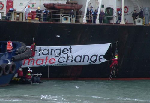Greenpeace activists board the coal bulk carrier Hellenic Sea and unfurl a protest banner