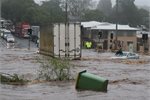 A woman trapped on the roof of her car during a flash flood in Queensland. A woman trapped on the roof of her car during a flash flood in Queensland.