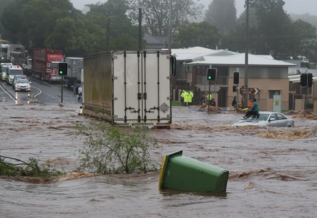 A woman trapped on the roof of her car during a flash flood in Queensland.