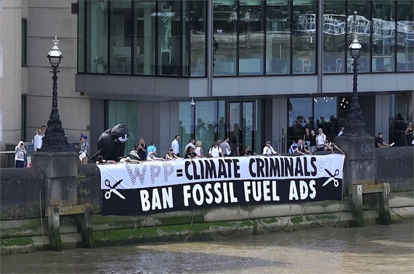 Activists at the June protest unfurled a 15-metre-long in front of the headquarters of WPP, reading "WPP are climate criminals, ban fossil fuel advertising".