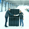 Snowplanet General Manager, Rojie Aguilar, right, and Sunergise Installation Business Manager, James Hogg, with one of the 2,317 installed solar panels that help keep the slopes frozen