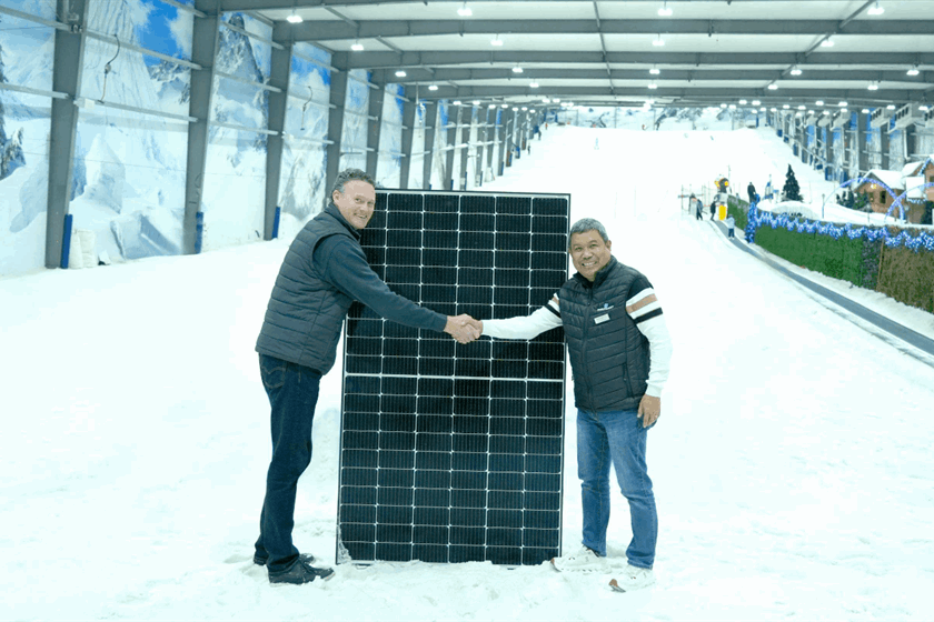 Snowplanet General Manager, Rojie Aguilar, right, and Sunergise Installation Business Manager, James Hogg, with one of the 2,317 installed solar panels that help keep the slopes frozen