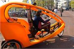 Bicycle-taxi in the streets of Amsterdam. Bicycle-taxi in the streets of Amsterdam.
