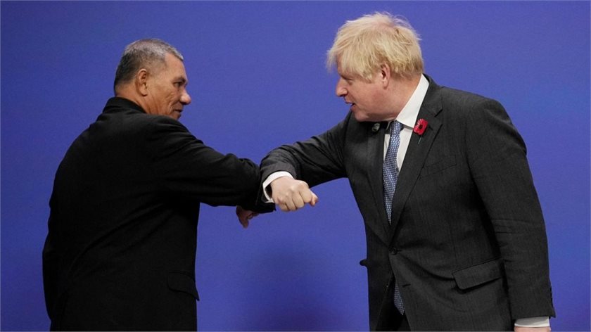 Tuvalu PM Kausea Natano and UK PM Boris Johnson bumping arms